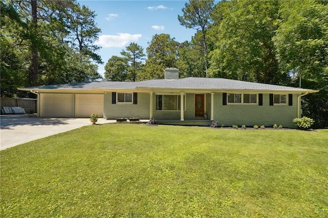 ranch-style house featuring a garage and a front lawn