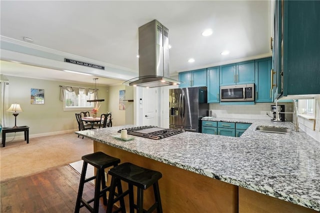 1192 Eastridge Rd SW, Atlanta, GA 30311 - kitchen featuring a kitchen bar, stainless steel appliances, island range hood, blue cabinets, and dark hardwood / wood-style flooring
