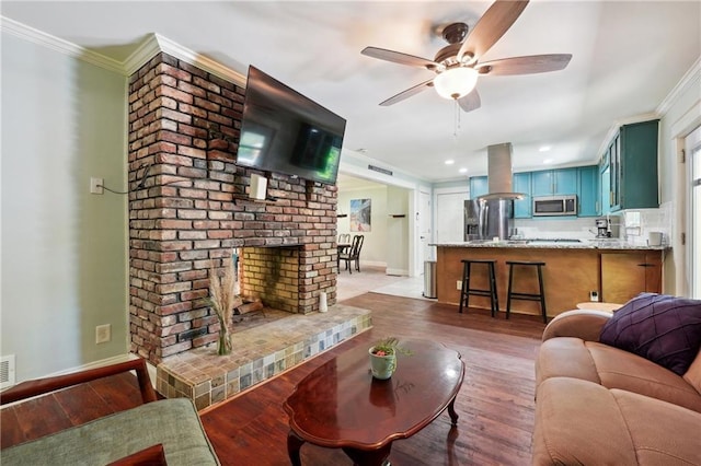 1192 Eastridge Rd SW, Atlanta, GA 30311 - living room featuring dark wood-type flooring, ceiling fan, a fireplace, and crown molding
