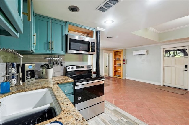 1192 Eastridge Rd SW, Atlanta, GA 30311 - kitchen featuring crown molding, appliances with stainless steel finishes, a wall mounted AC, tasteful backsplash, and light stone countertops