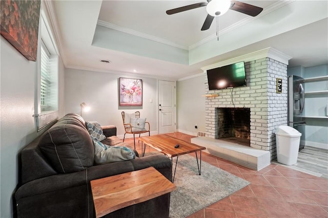 1192 Eastridge Rd SW, Atlanta, GA 30311 - tiled living room with crown molding, a fireplace, a tray ceiling, and ceiling fan