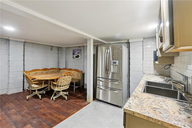 1192 Eastridge Rd SW, Atlanta, GA 30311 - kitchen featuring light stone countertops, sink, and stainless steel fridge
