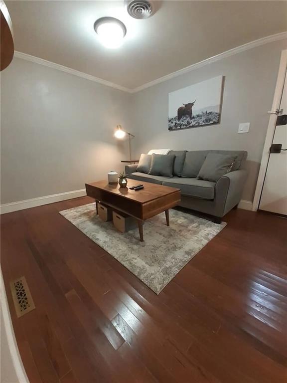 1192 Eastridge Rd SW, Atlanta, GA 30311 - living room featuring hardwood / wood-style flooring and crown molding