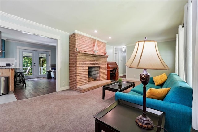 1192 Eastridge Rd SW, Atlanta, GA 30311 - carpeted living room with crown molding, a brick fireplace, and french doors