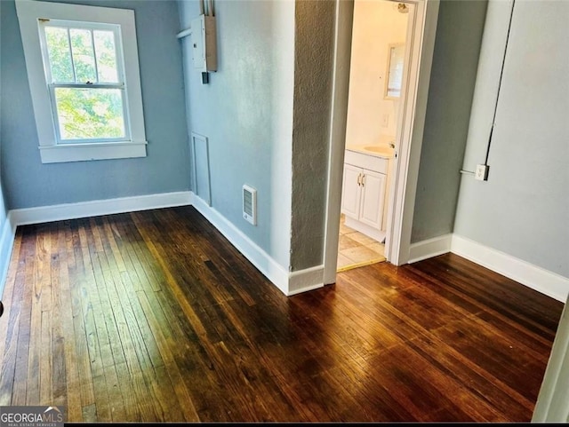430 E 23rd St, Anniston, AL 36207 - empty room featuring dark wood-type flooring and baseboards