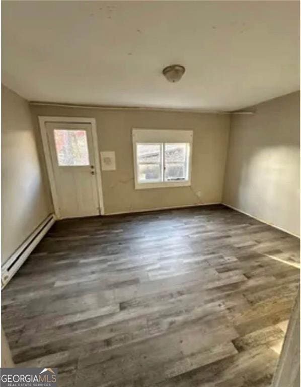 430 E 23rd St, Anniston, AL 36207 - foyer entrance with a baseboard radiator, plenty of natural light, wood finished floors, and baseboards