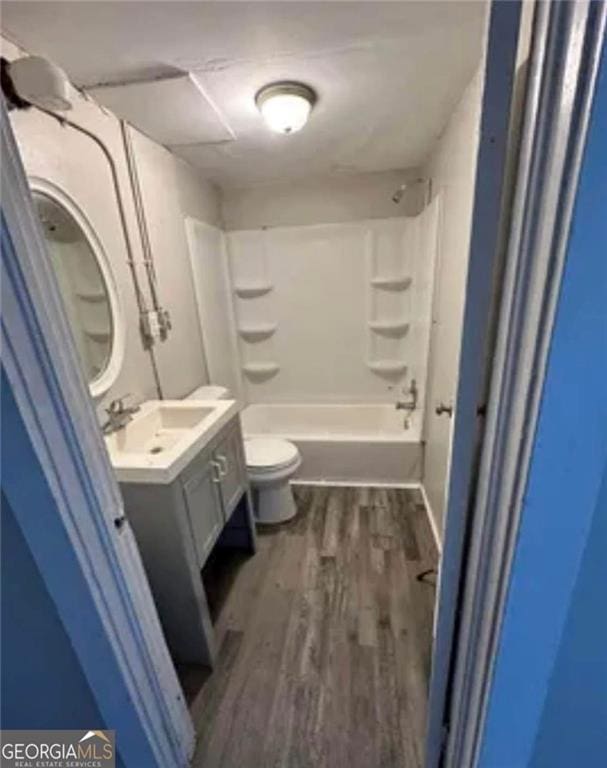 430 E 23rd St, Anniston, AL 36207 - full bath with vanity, toilet, wood finished floors, and  shower combination