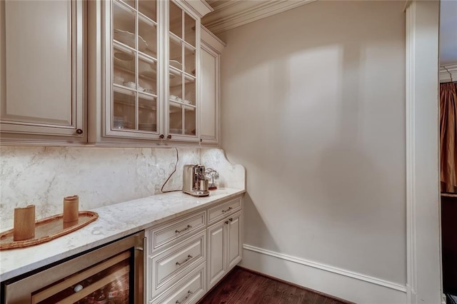 kitchen with dark wood-type flooring, light stone counters, crown molding, beverage cooler, and backsplash