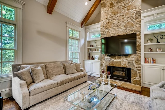 living room with dark hardwood / wood-style floors, a fireplace, high vaulted ceiling, beam ceiling, and a wealth of natural light