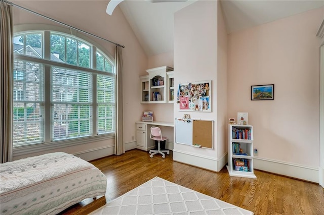 bedroom featuring multiple windows, vaulted ceiling, and light wood-type flooring