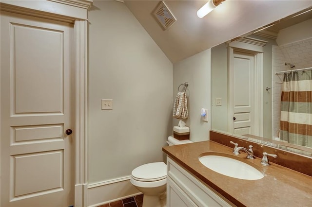 bathroom featuring oversized vanity, toilet, tile floors, and lofted ceiling