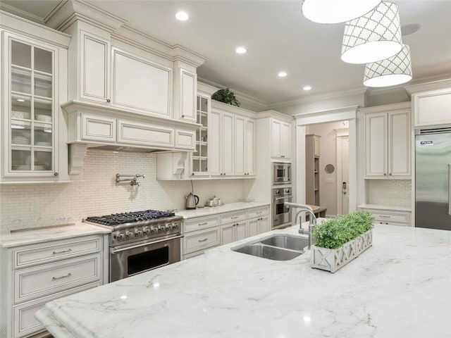 kitchen with tasteful backsplash, built in appliances, pendant lighting, and light stone counters