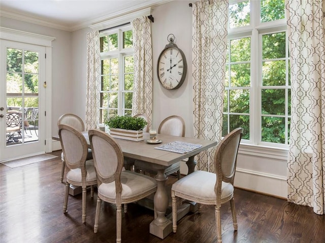 dining room with ornamental molding, dark wood-type flooring, and a healthy amount of sunlight