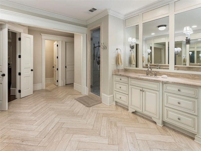 bathroom with an inviting chandelier, vanity, parquet flooring, and ornamental molding