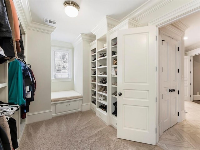 spacious closet with light parquet flooring