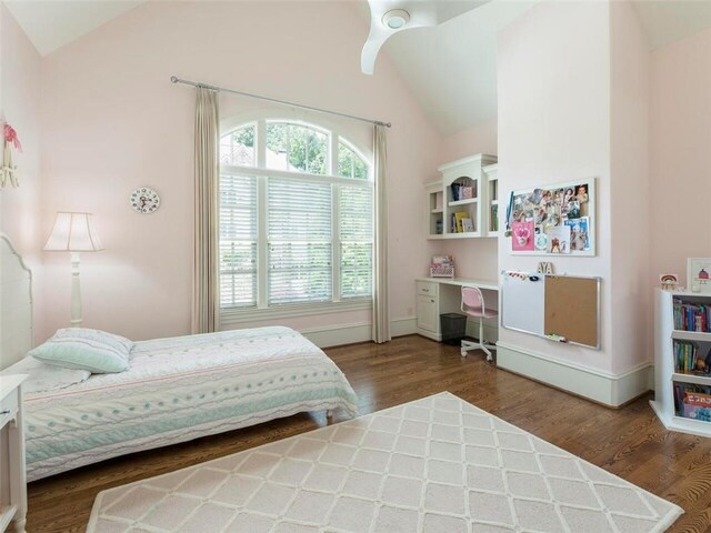 bedroom featuring dark wood-type flooring and vaulted ceiling