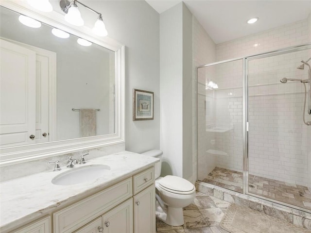 bathroom featuring walk in shower, tile floors, oversized vanity, and toilet