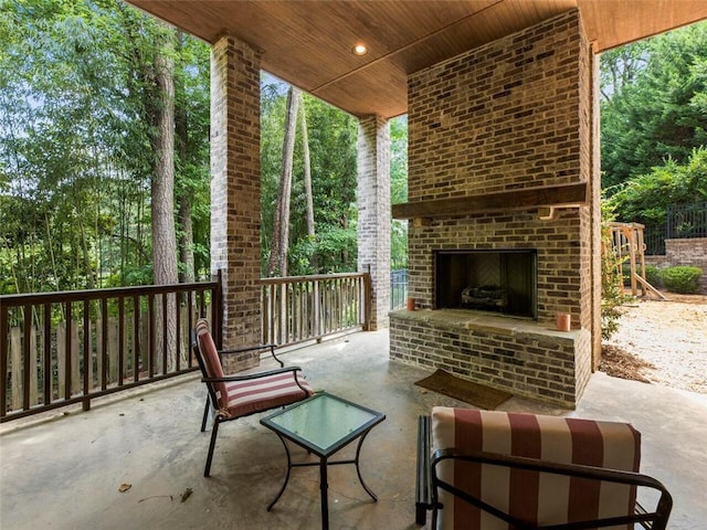 view of patio / terrace featuring an outdoor brick fireplace