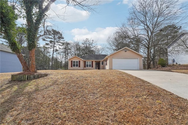 ranch-style house featuring a front yard, driveway, and an attached garage