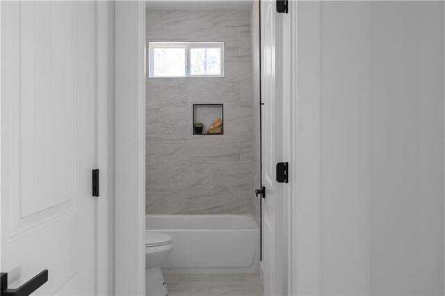 bathroom featuring toilet and shower / bathing tub combination