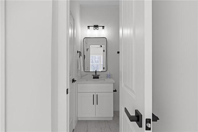 bathroom with marble finish floor and vanity