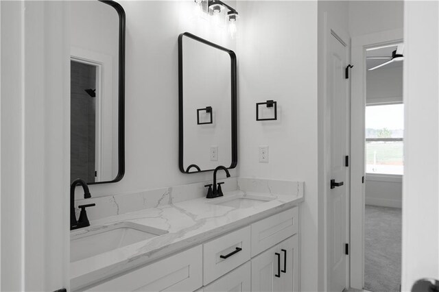bathroom with a sink and double vanity