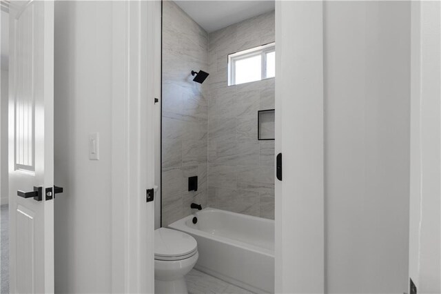full bathroom with toilet and bathing tub / shower combination