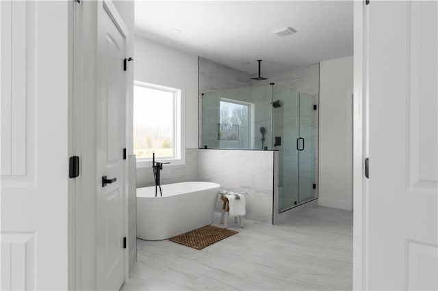 full bath with a freestanding tub and a shower stall