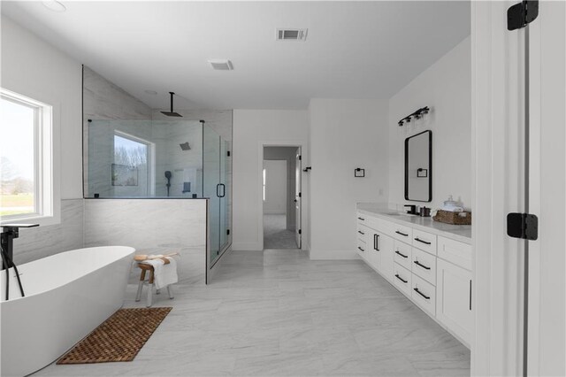 full bath featuring vanity, a shower stall, visible vents, and marble finish floor