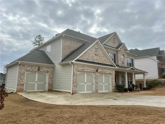 craftsman house with a garage and a front yard