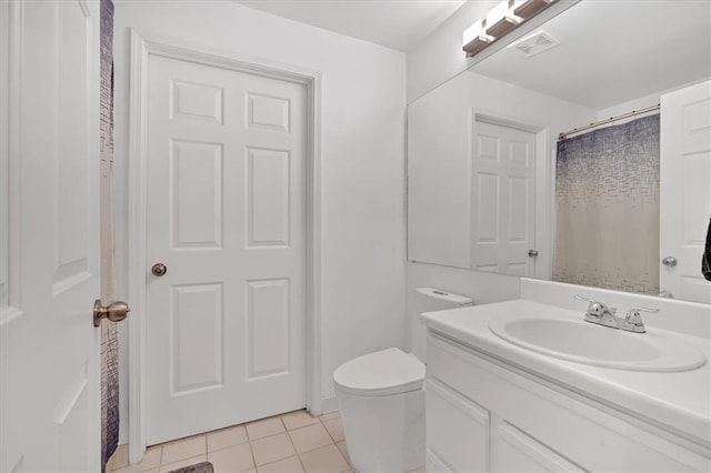 bathroom with vanity, tile patterned floors, and toilet