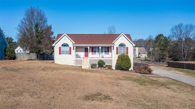 single story home featuring covered porch and a front lawn