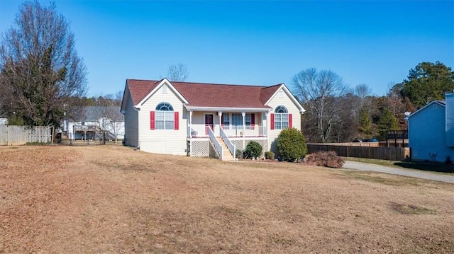 view of front of home with covered porch and a front yard