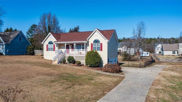 view of front facade with a front lawn and covered porch