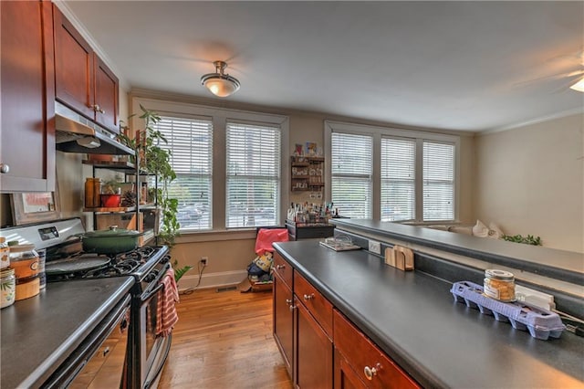 kitchen with ceiling fan, light hardwood / wood-style flooring, stainless steel gas range, and ornamental molding