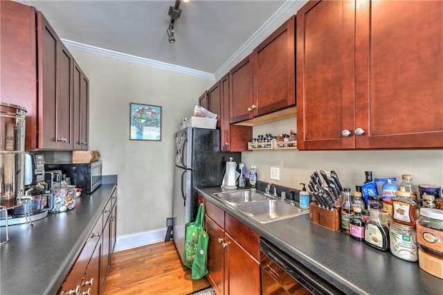 kitchen with appliances with stainless steel finishes, light wood-type flooring, track lighting, ornamental molding, and sink