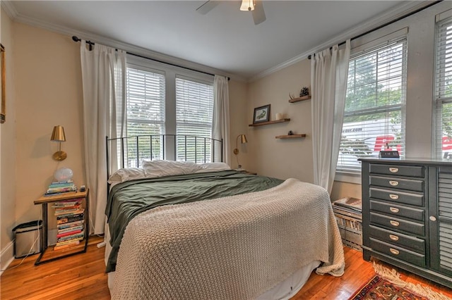 bedroom with ornamental molding, light hardwood / wood-style floors, and ceiling fan