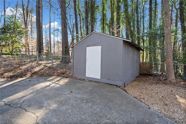 view of shed featuring fence