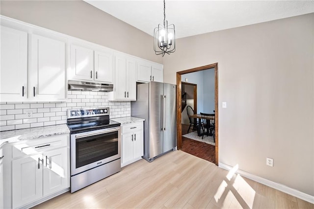 kitchen featuring under cabinet range hood, backsplash, white cabinetry, appliances with stainless steel finishes, and a chandelier