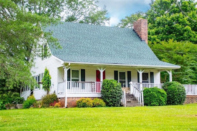 view of front of home featuring covered porch, a front lawn, a chimney, and a shingled roof