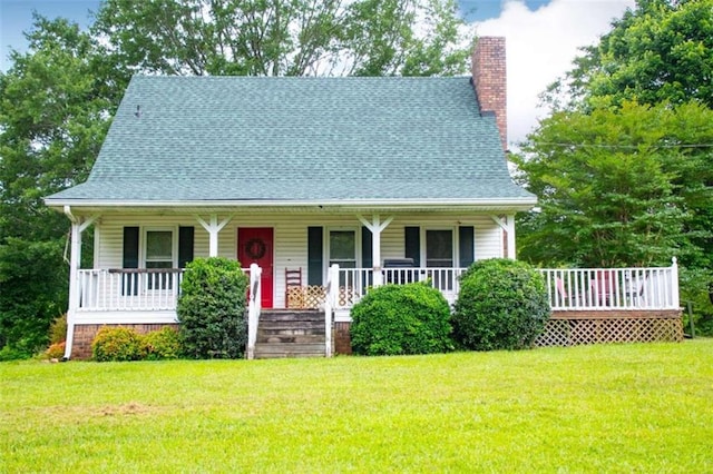 view of front of home with a front yard and covered porch