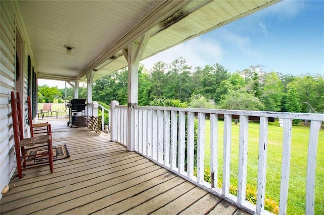 deck with area for grilling and a yard