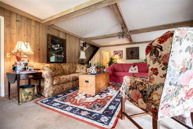 carpeted living room with wood walls and beamed ceiling