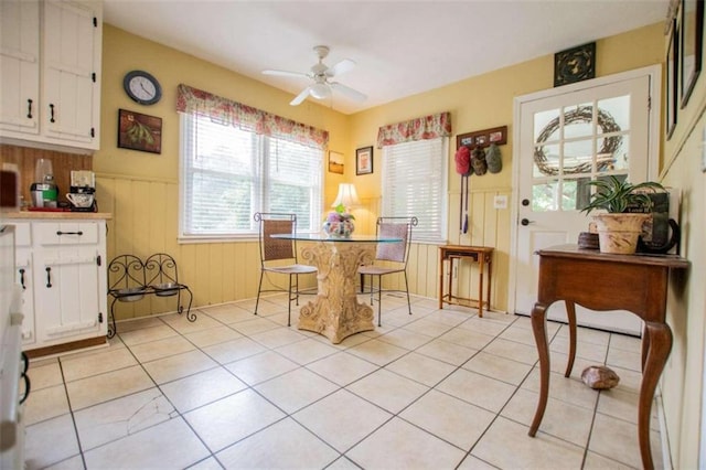 dining space with ceiling fan and light tile patterned floors