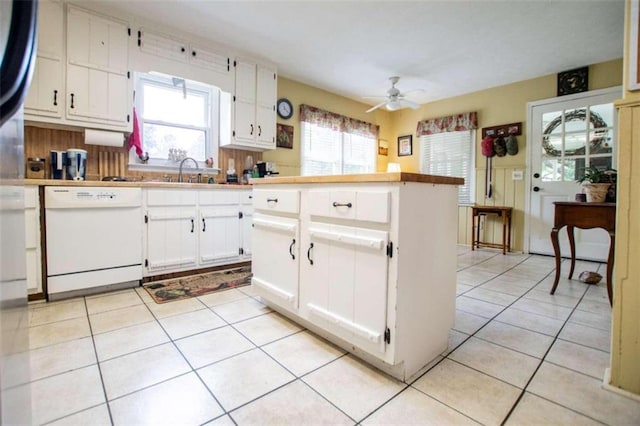 kitchen featuring light tile patterned floors, a healthy amount of sunlight, ceiling fan, and dishwasher