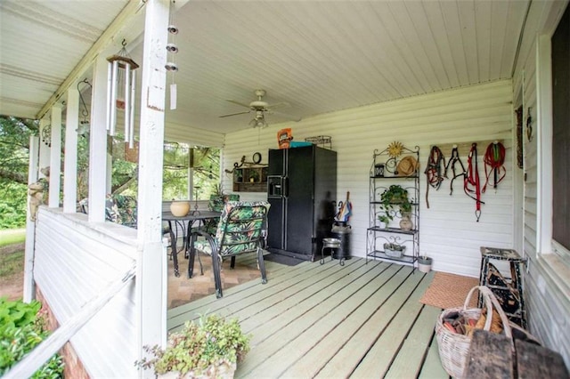 wooden deck featuring ceiling fan