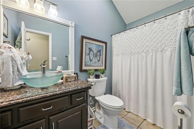 bathroom featuring toilet, a textured ceiling, vanity, and tile patterned floors