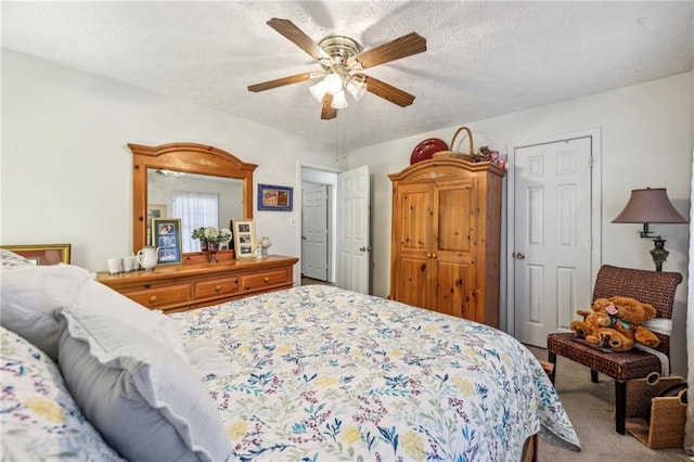 bedroom featuring light carpet, a textured ceiling, and ceiling fan