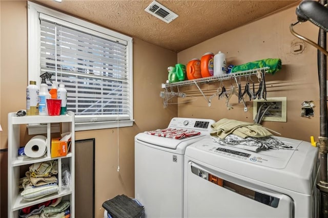 laundry area featuring a textured ceiling and independent washer and dryer