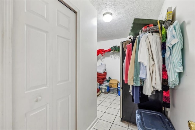 walk in closet with light tile patterned flooring